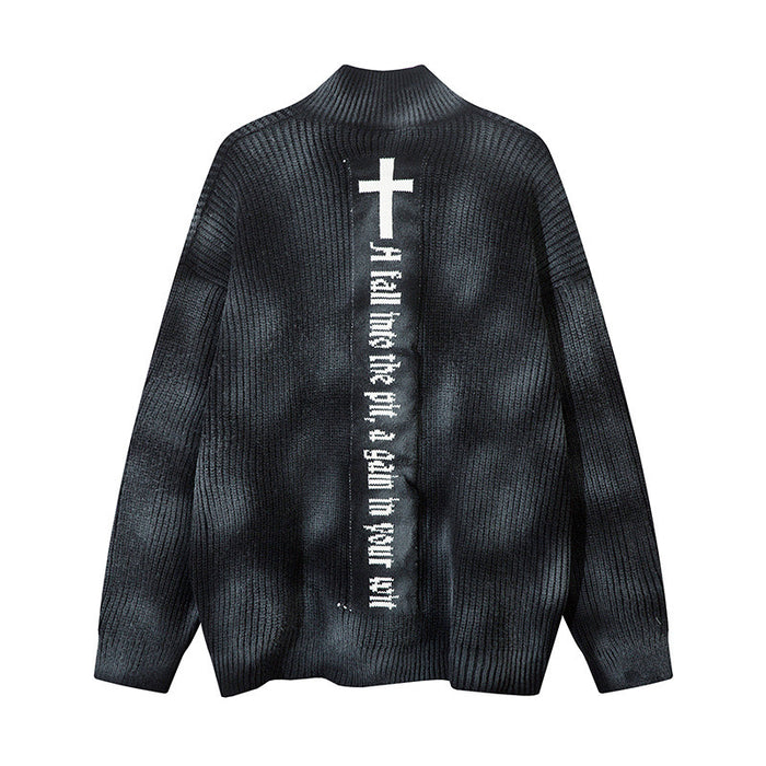 Black rib-knit cardigan shown from the back with a large white cross and vertical gothic-style text panel