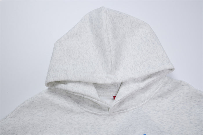 Close-up of the heather gray hoodie showing the lined hood, neckline, and textured fabric