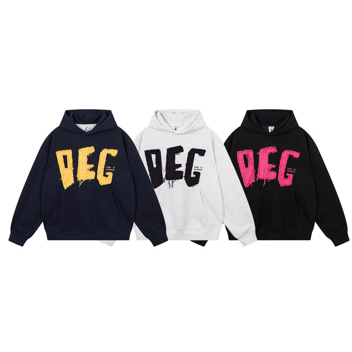 Three oversized hoodies in navy, light gray, and black with contrasting frayed DEG appliqué lettering