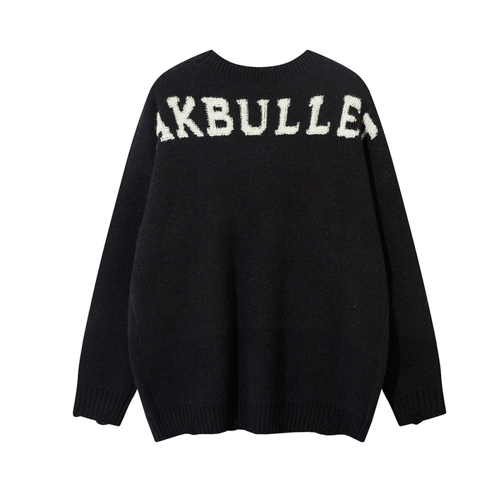 Black oversized knit sweater back with cream lettering across the upper shoulders