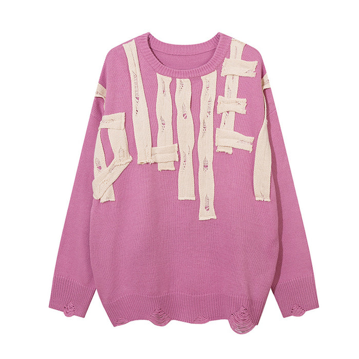 Pink knit crewneck sweater front with distressed cream letter appliqués and frayed hem details