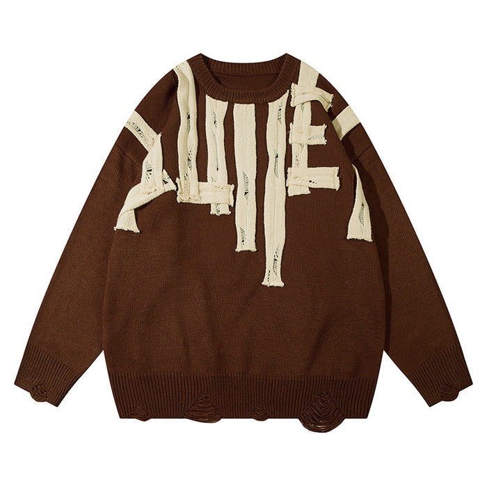 Brown knit crewneck sweater front with cream distressed letter appliqués and ribbed cuffs