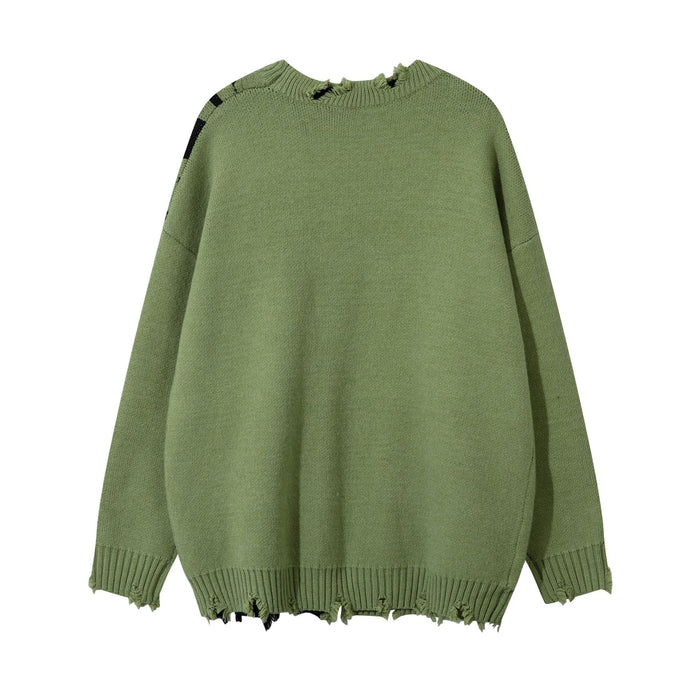 Olive green knit sweater back showing its plain texture, long sleeves, ribbed cuffs, and frayed hem