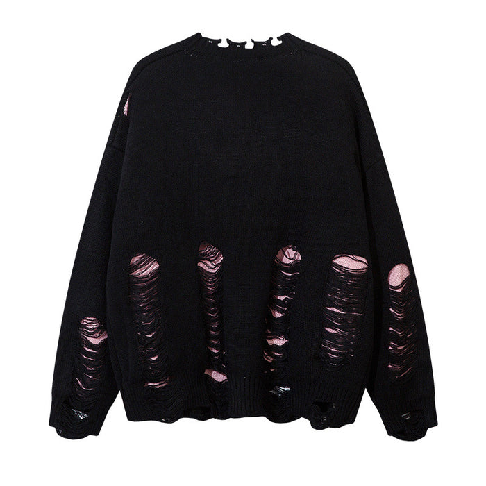 Back view of a black knit cardigan featuring vertical rows of pink-backed distressed openings across the lower section