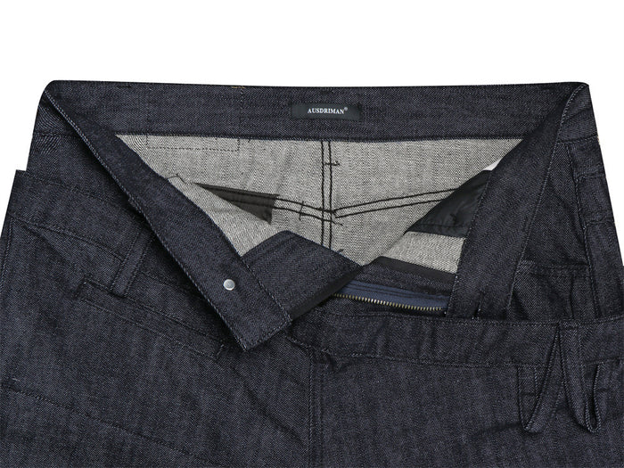 Inside view of the jeans waistband showing the light woven lining, button closure, interior stitching, and zipper fly
