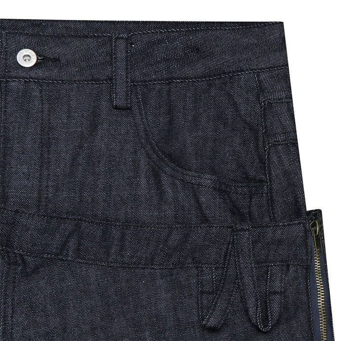 Close-up of the jeans front pocket area showing the button, belt loop, curved pocket seam, and side zipper