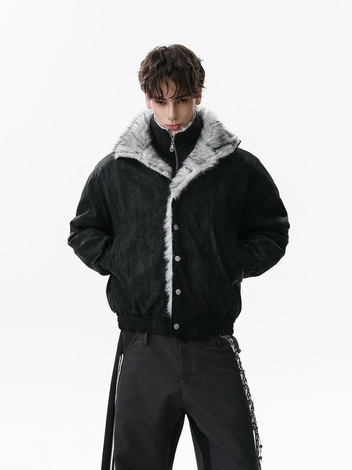 Model wearing the black faux fur collar bomber jacket closed, with hands in its side pockets