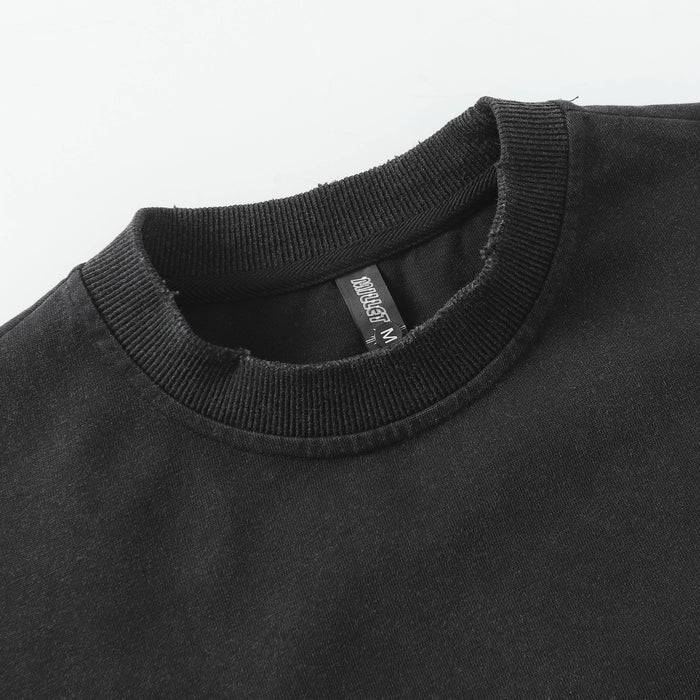 Close-up of the ribbed black crew neckline and interior clothing label