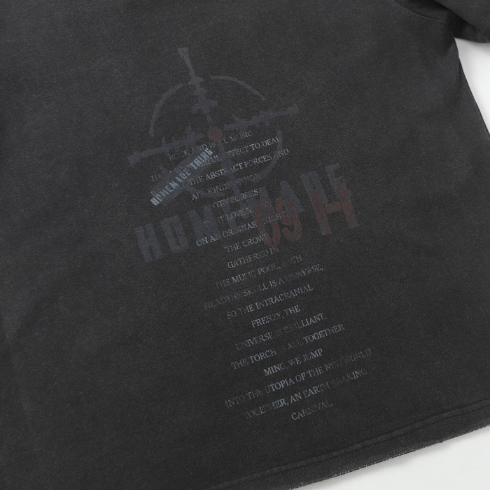 Close-up of the faded dark front graphic and distressed texture on the black tee body
