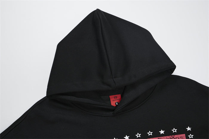 Close-up of the black hoodie hood and neckline with visible stitching and inner label