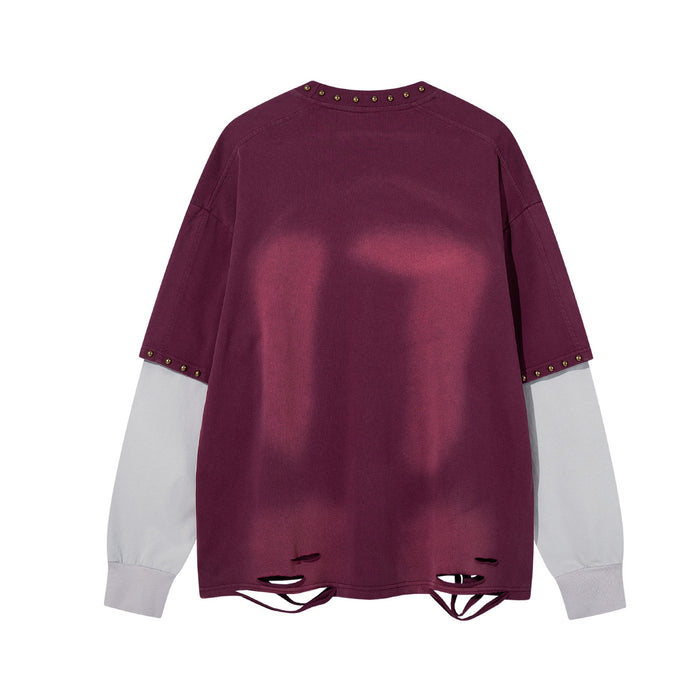 Back view of a burgundy long sleeve shirt with white sleeves, studded trim and distressed cutout hem