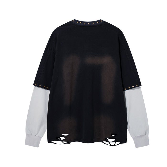 Back view of a black long sleeve shirt with white sleeves, studded trim and distressed cutout hem