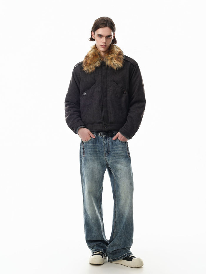 Model wearing a dark brown padded jacket with a fluffy tan fur collar and relaxed bomber silhouette