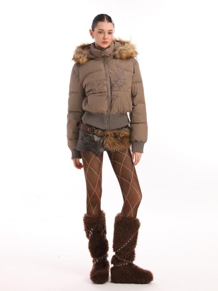Full-length model view of a taupe cropped puffer jacket with fur-trimmed hood and thorn embroidery