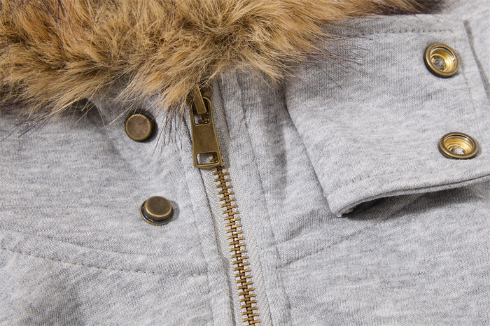 Close-up of the gray hoodie jacket's brass zipper, snap buttons, and tan fur-trimmed hood edge