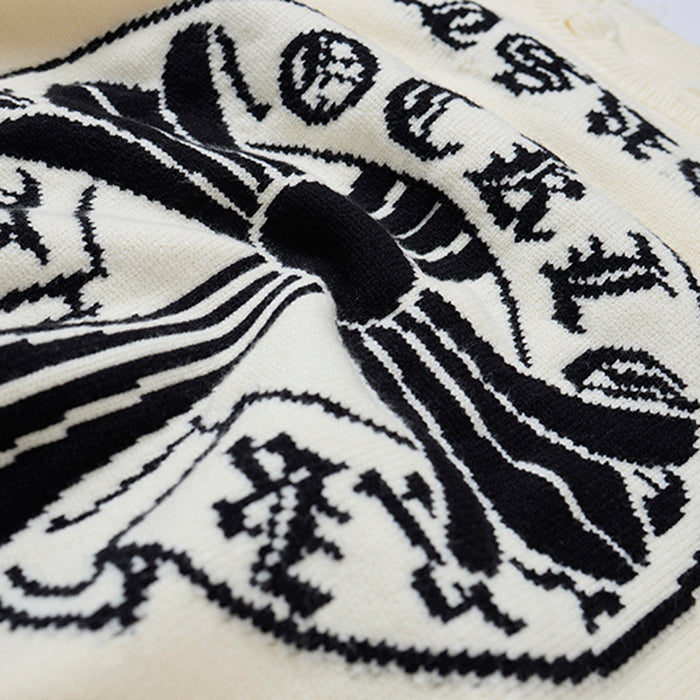 Close-up of the sweater's black and cream knitted cross graphic with ornate lettering details