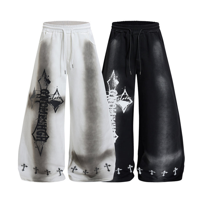 Wide-leg sweatpants in white and black with gray shading, large cross graphics, and small crosses at the hems