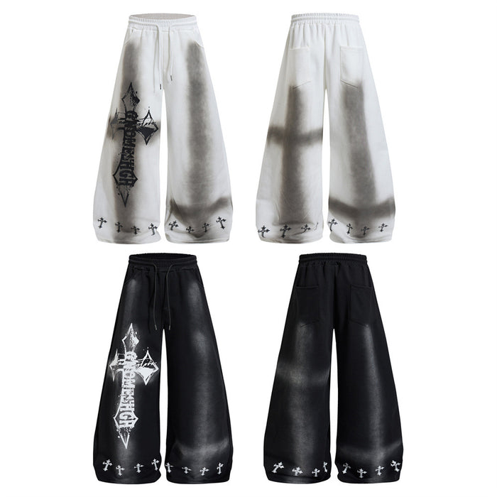 White and black wide-leg sweatpants shown from front and back, with cross graphics and elastic waistbands