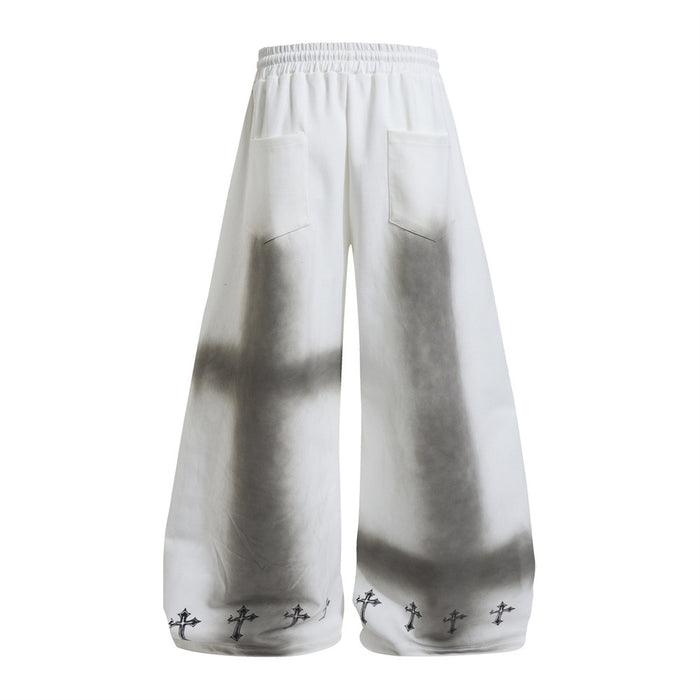 Back view of white wide-leg sweatpants with gray shading, two patch pockets, and small cross prints at the hems