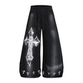 Front view of black wide-leg sweatpants with a large distressed white cross graphic and small crosses along the hems