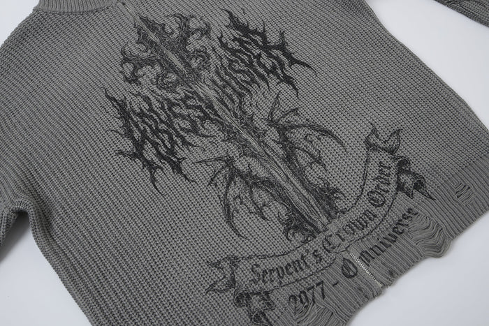 Close-up of the gray sweater front showing its dark gothic graphic, banner lettering, and textured knit fabric