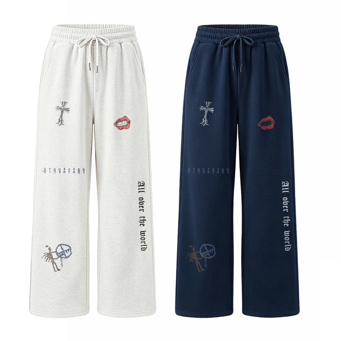 Front view of white and navy wide-leg sweatpants with drawstrings and gothic graphic prints