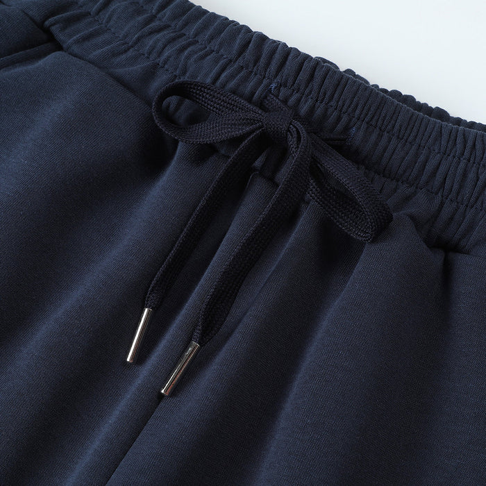 Detailed view of the navy elastic waistband with tied drawstring and silver-toned metal tips