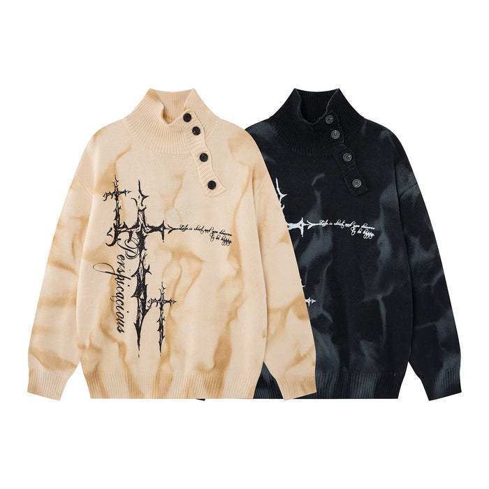 Front view of cream and black marbled knit turtleneck sweaters with thorny cross graphics and diagonal buttons