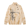 Front view of the cream marbled knit turtleneck sweater with black thorny cross graphic and diagonal buttons