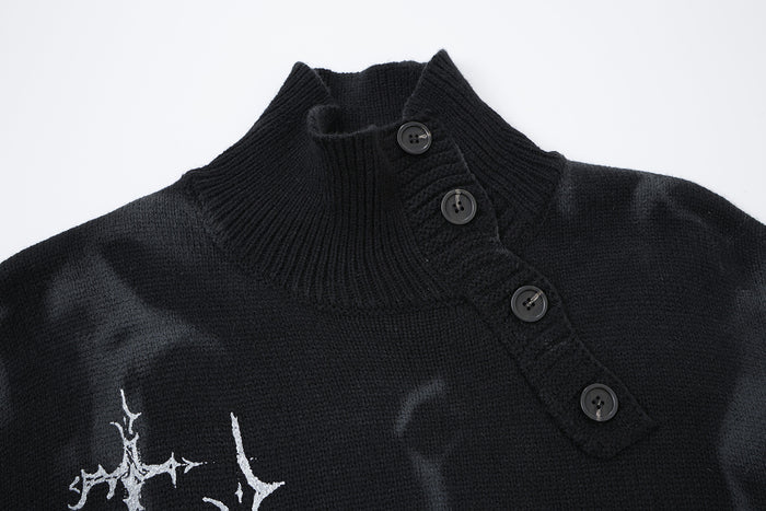 Close-up of the black knit sweater’s ribbed turtleneck and diagonal button placket
