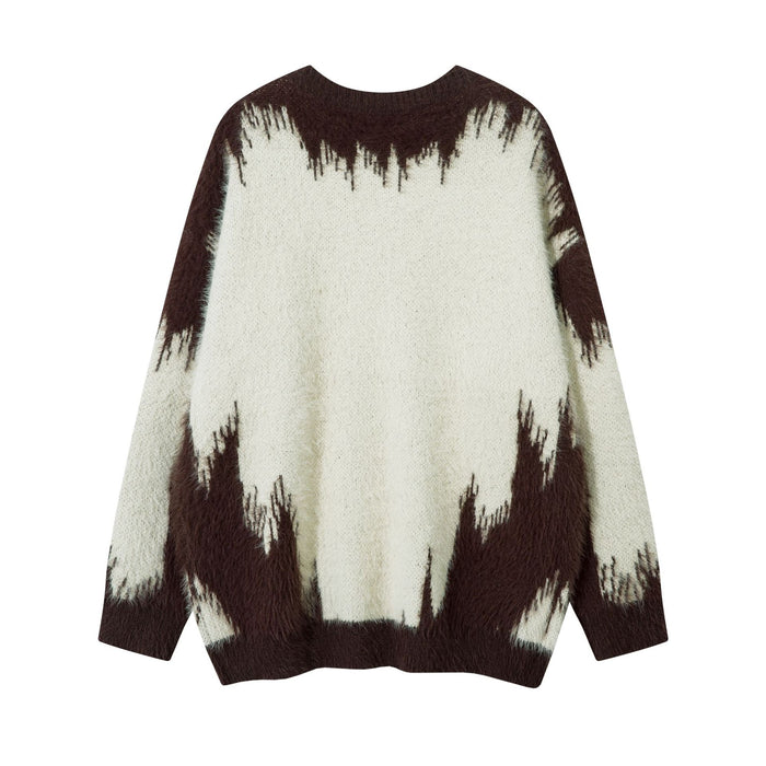 Back view of a cream and dark brown fuzzy knit sweater with a jagged gradient pattern and ribbed cuffs
