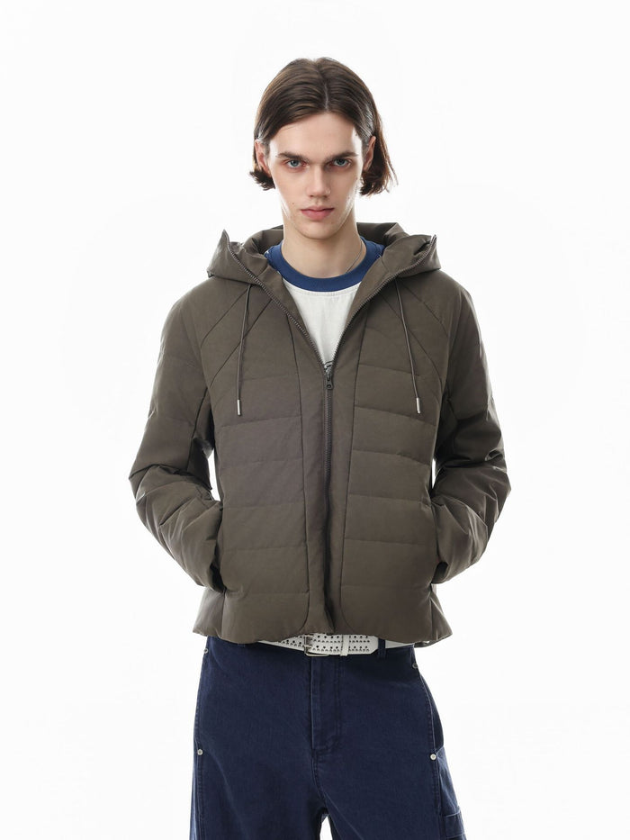 Hooded quilted puffer jacket with ribbed front panel and drawstring hood in olive khaki, worn by male model