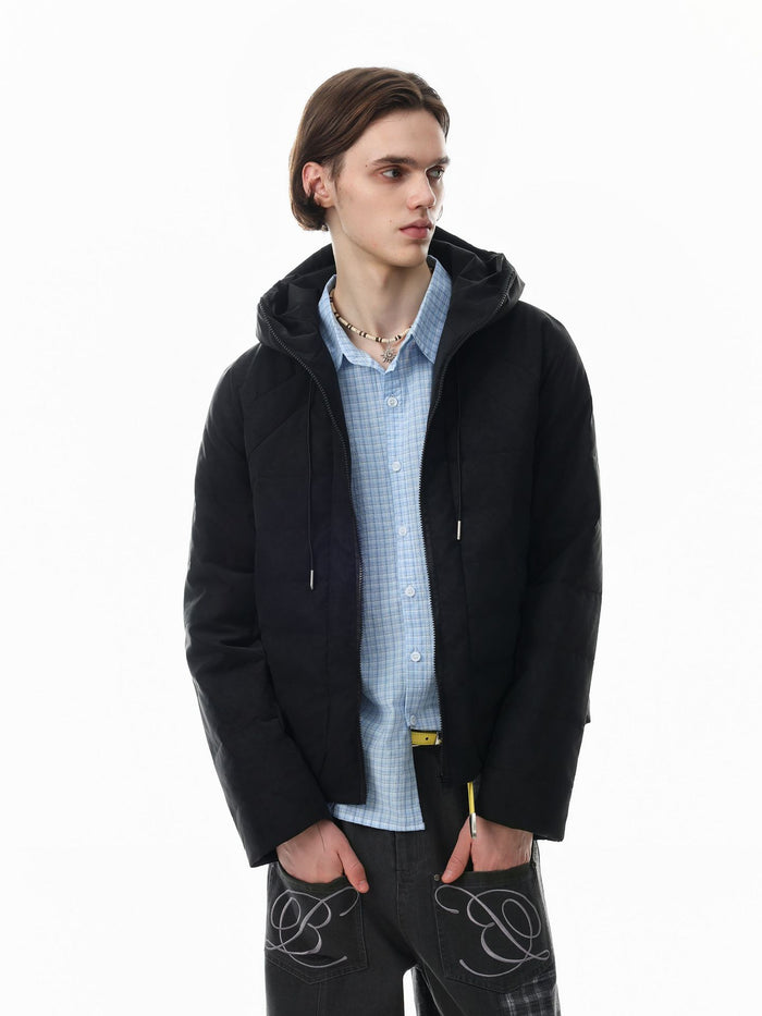 Black hooded quilted puffer jacket worn open over a blue shirt in a three-quarter view