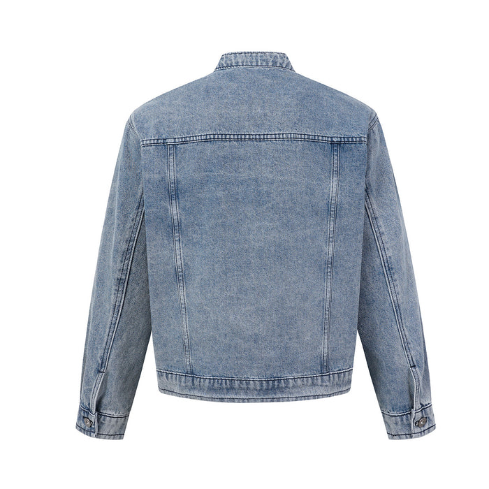 Back view of a washed blue denim trucker jacket with stand collar, yoke seam, long sleeves, and hem