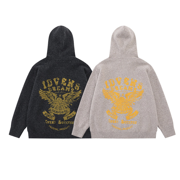 Black and light beige knit hoodies shown from the back, each featuring a large gold eagle graphic