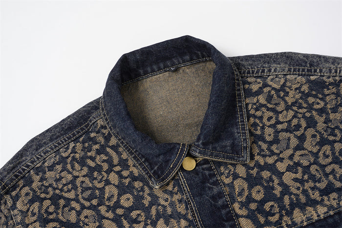 Close-up of the denim jacket collar and upper chest showing tan leopard jacquard and brass button