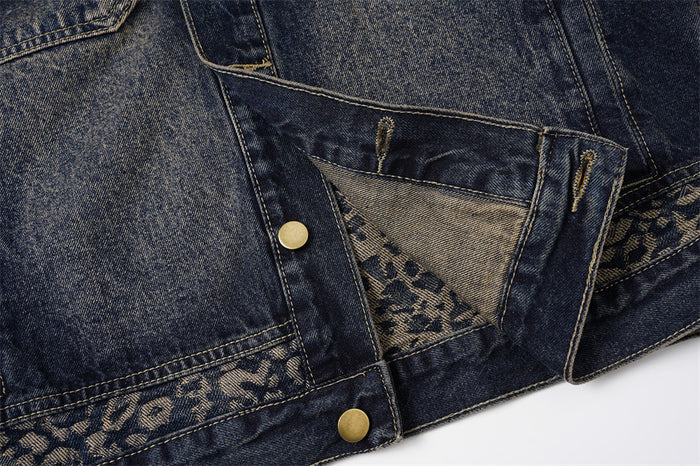 Close-up of the jacket lower detail showing an opened snap tab and visible leopard-patterned inner fabric
