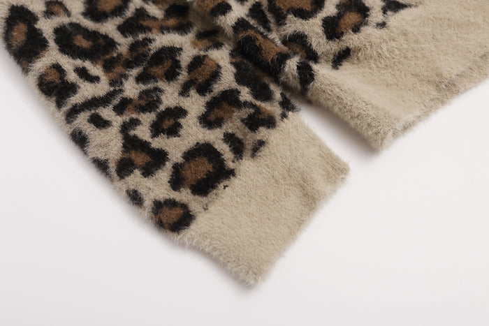 Close-up of the jacket sleeve showing leopard print fuzzy fabric and a contrasting ribbed beige cuff