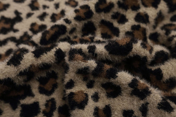Close-up of the jacket’s plush fuzzy leopard print texture in taupe, brown, and black