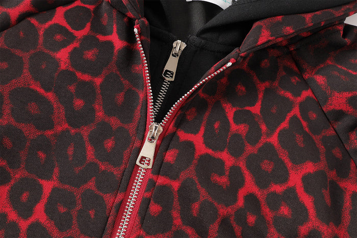 Close-up of the silver zipper and red and black leopard-print fabric on the hoodie jacket