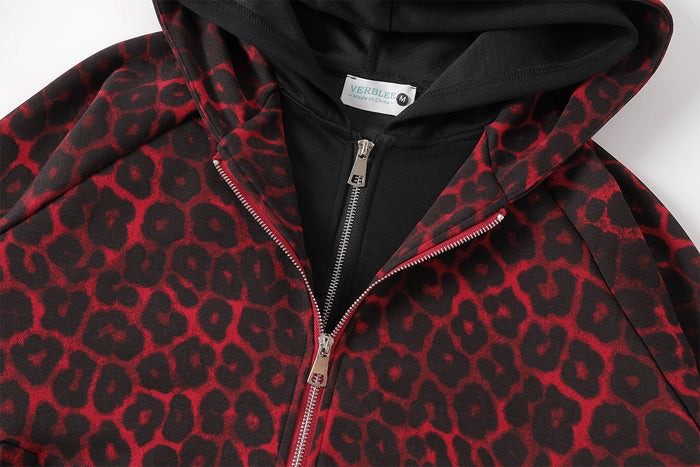 Upper jacket detail showing the black-lined hood, zipper, collar, and red leopard-print pattern