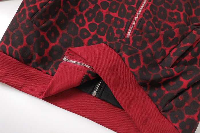 Close-up of the jacket hem showing red ribbed trim, zipper edge, and black inner lining