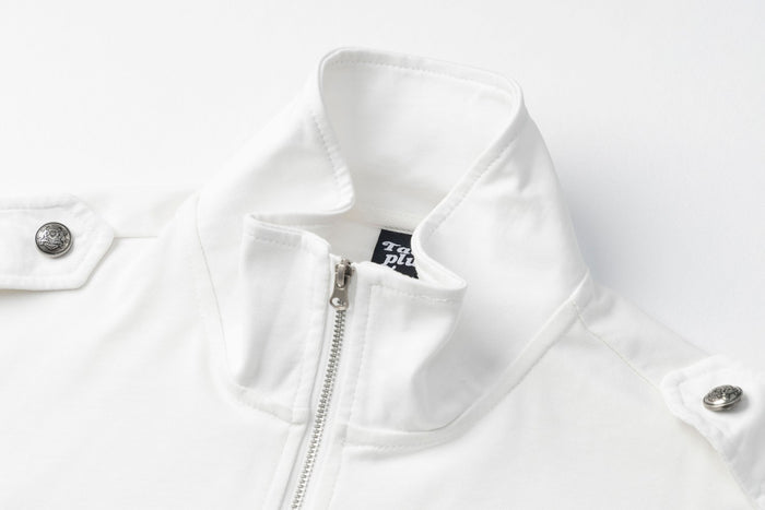 Close-up of the white shirt's stand collar, silver half-zipper, shoulder snap, and fine textured fabric