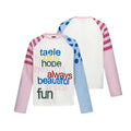 Colorblock raglan baby tee shown front and back with pink and blue sleeves, striped panels, and multicolor text graphic