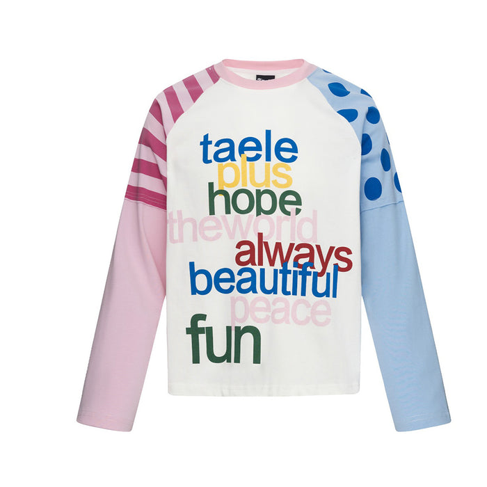 White long sleeve baby tee with blue polka-dot and pink stripe colorblock raglan sleeves and multicolor word graphic print on