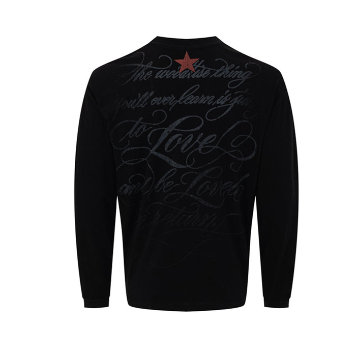 Back of a black long sleeve shirt with dark script lettering and a red star near the collar
