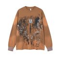 Front view of the tan oversized long sleeve shirt with a large black and white winged graphic and script print