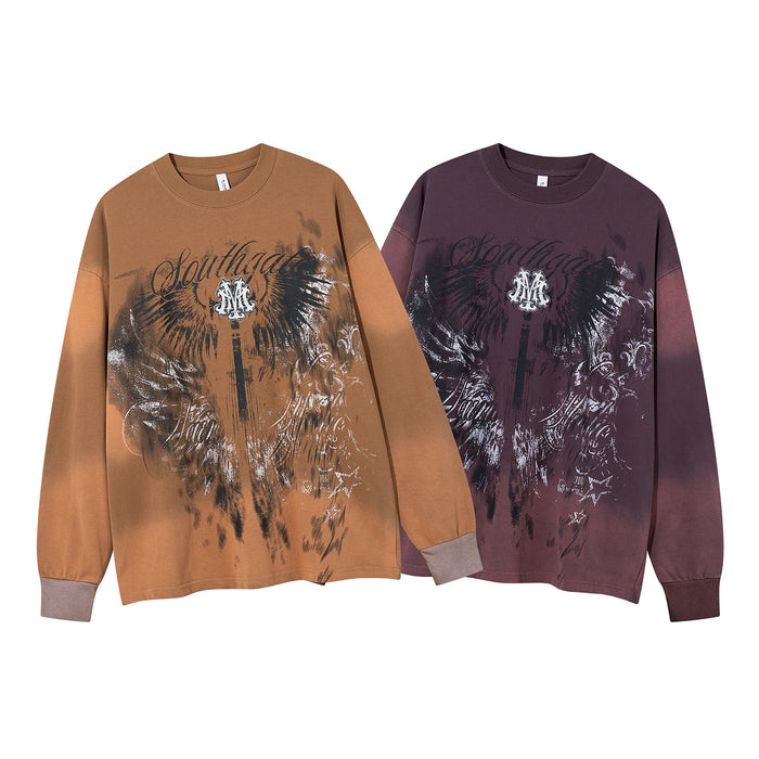 Two front-facing oversized long sleeve shirts in tan and deep plum with matching winged graphic prints