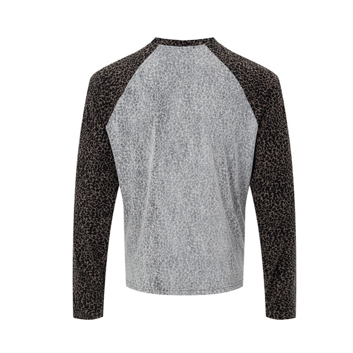 Back view of gray raglan tee featuring brown-black leopard-print raglan sleeves and a plain patterned back