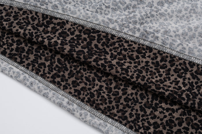 Close-up of brown-black leopard-print sleeve fabric between gray shirt panels with visible stitched seams